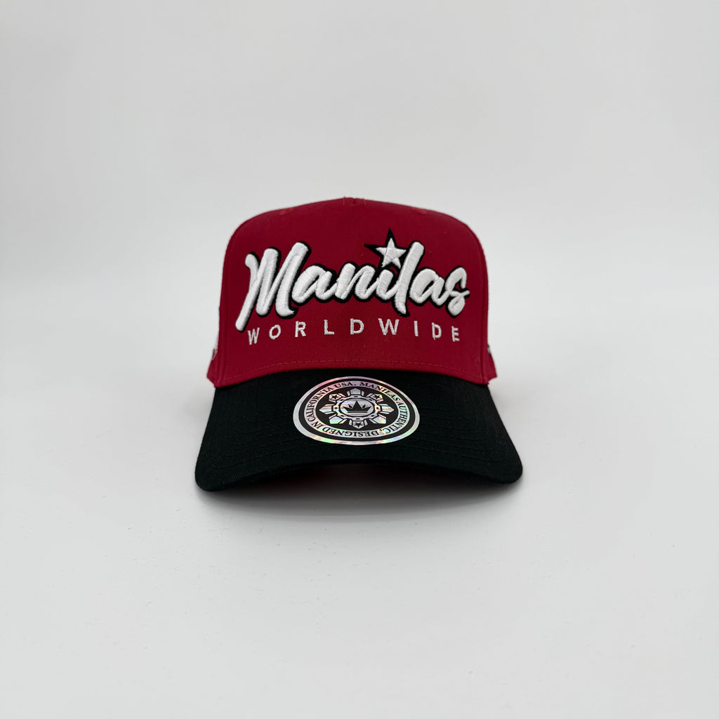 Two-tone red and black cap with 'Manilas Worldwide' logo on a white background
