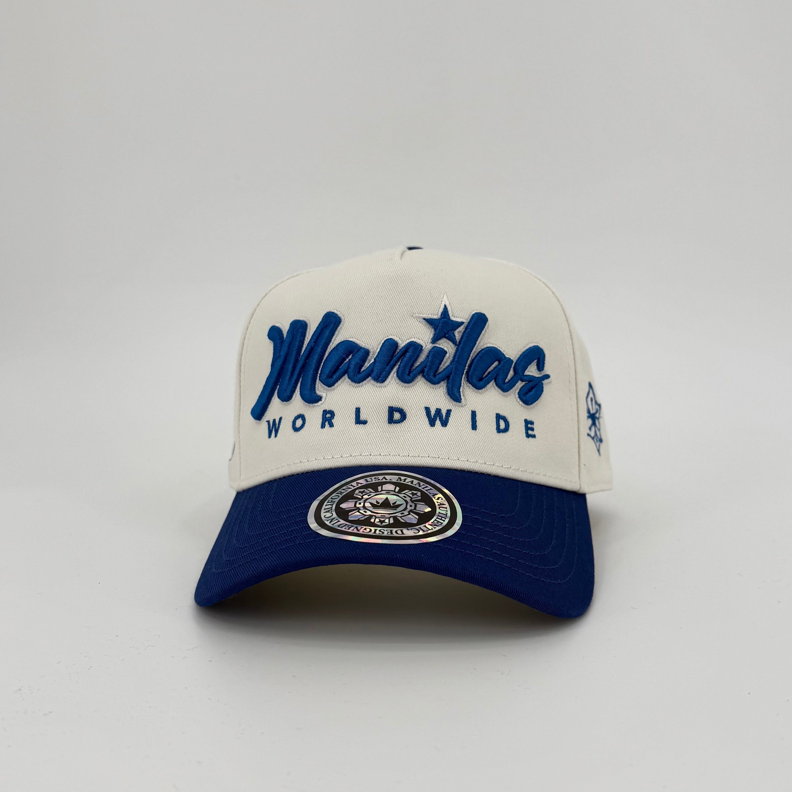 White and blue cap with 'Manilas Worldwide' text on a light gray background